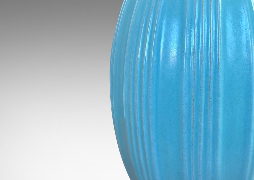 Gallery BAC upright pointed ovoid form, with vertical ribbing in relief, glazed in a soft blue-tinged celadon green