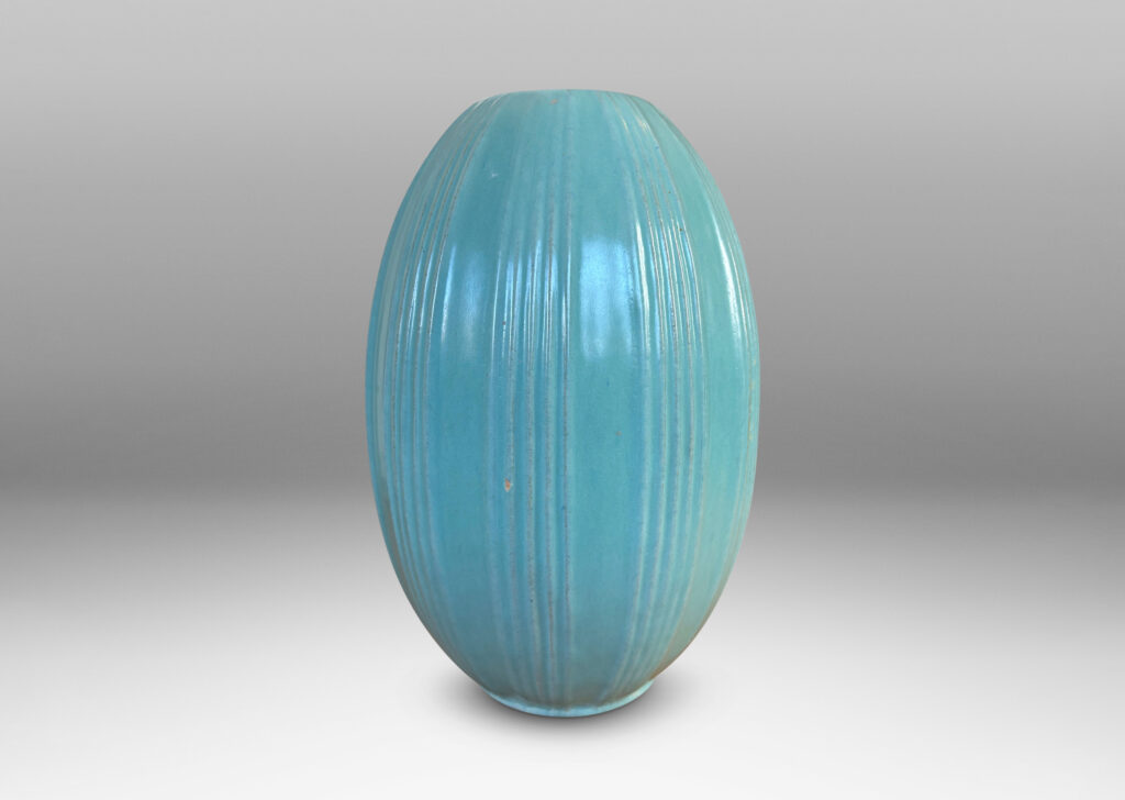 Gallery BAC upright pointed ovoid form, with vertical ribbing in relief, glazed in a soft blue-tinged celadon green