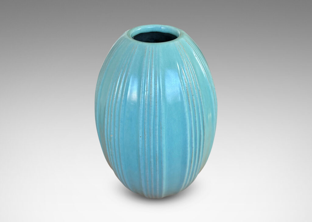 Gallery BAC upright pointed ovoid form, with vertical ribbing in relief, glazed in a soft blue-tinged celadon green