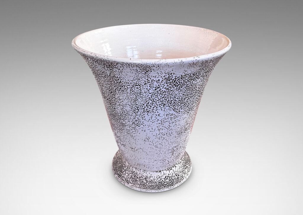 Gallery BAC lyre-silhouetted vase form on a flanged foot, glazed in white “crispé” glaze over matte brown