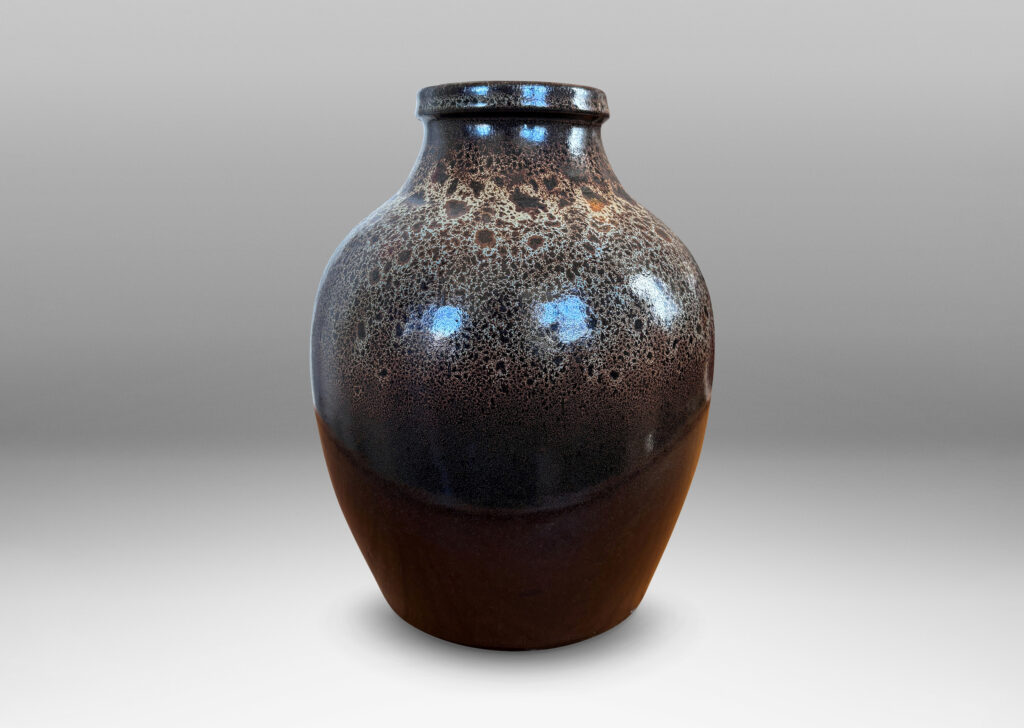Gallery BAC tapered apple-like forms with wide necks, glazed in dark brown with mantles of lighter speckling