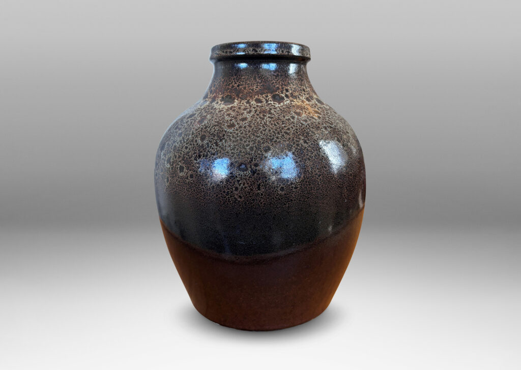 Gallery BAC tapered apple-like forms with wide necks, glazed in dark brown with mantles of lighter speckling