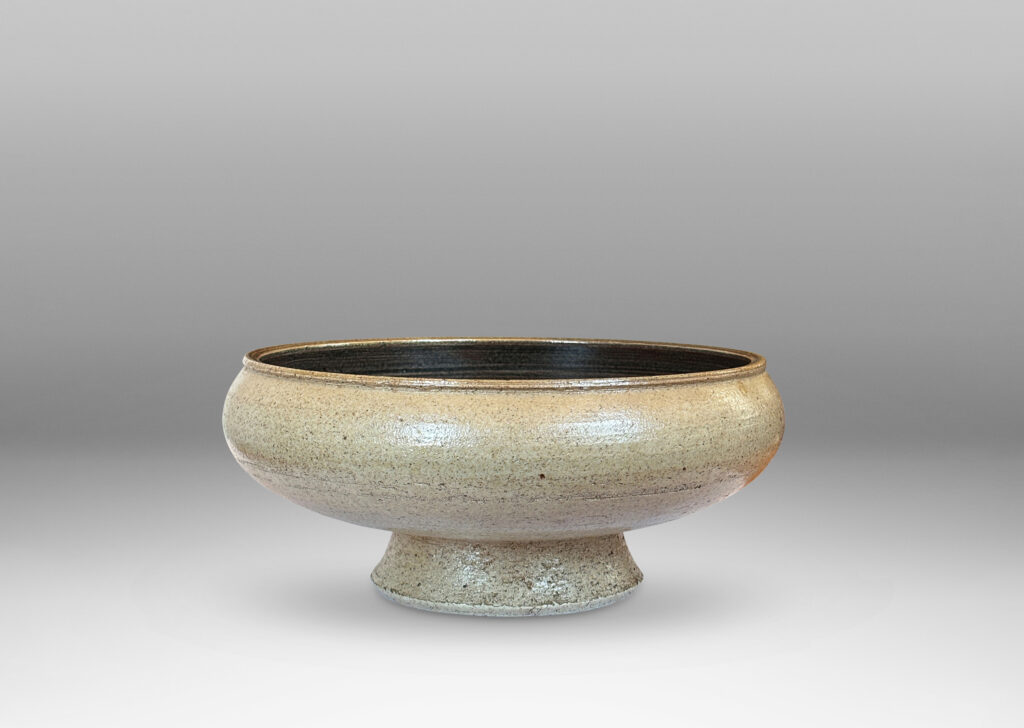 Gallery BAC softly molded sides and a flanged stand, glazed in pale gray and dark brown