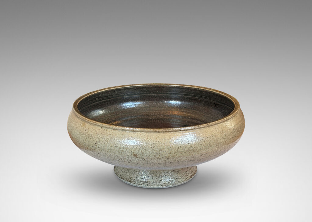 Gallery BAC softly molded sides and a flanged stand, glazed in pale gray and dark brown