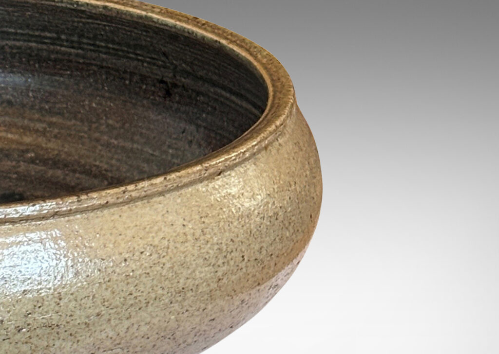 Gallery BAC softly molded sides and a flanged stand, glazed in pale gray and dark brown