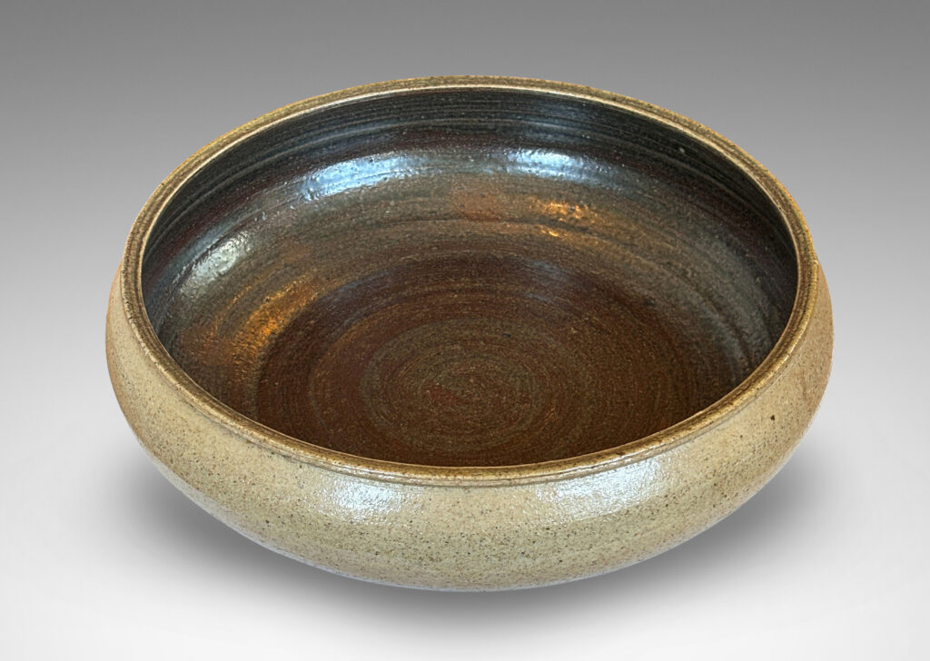 Gallery BAC softly molded sides and a flanged stand, glazed in pale gray and dark brown