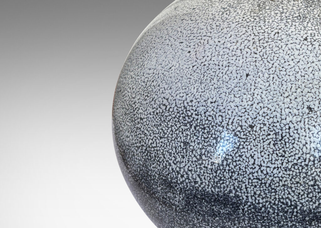 Gallery BAC wide globe form in white with dark gray stipple-glazed earthenware