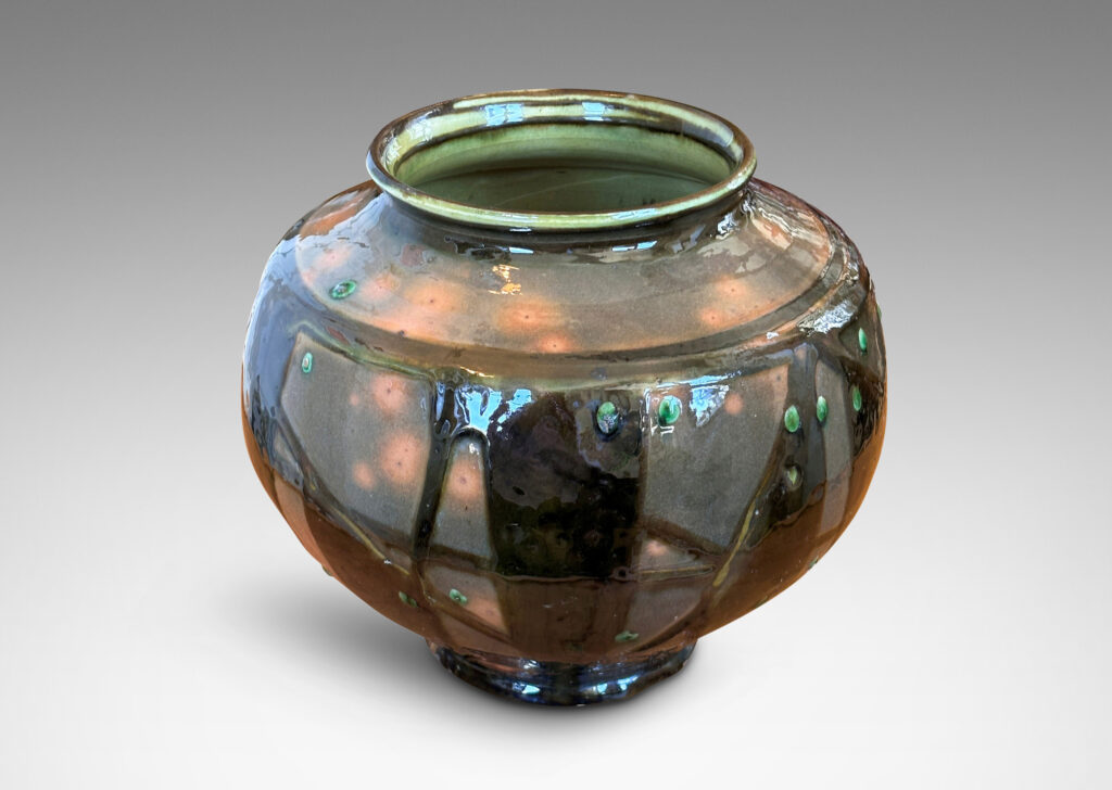 Gallery BAC wide tapered form with large mouth, glazed in orange-brown with dark brown and green piped ornamentation