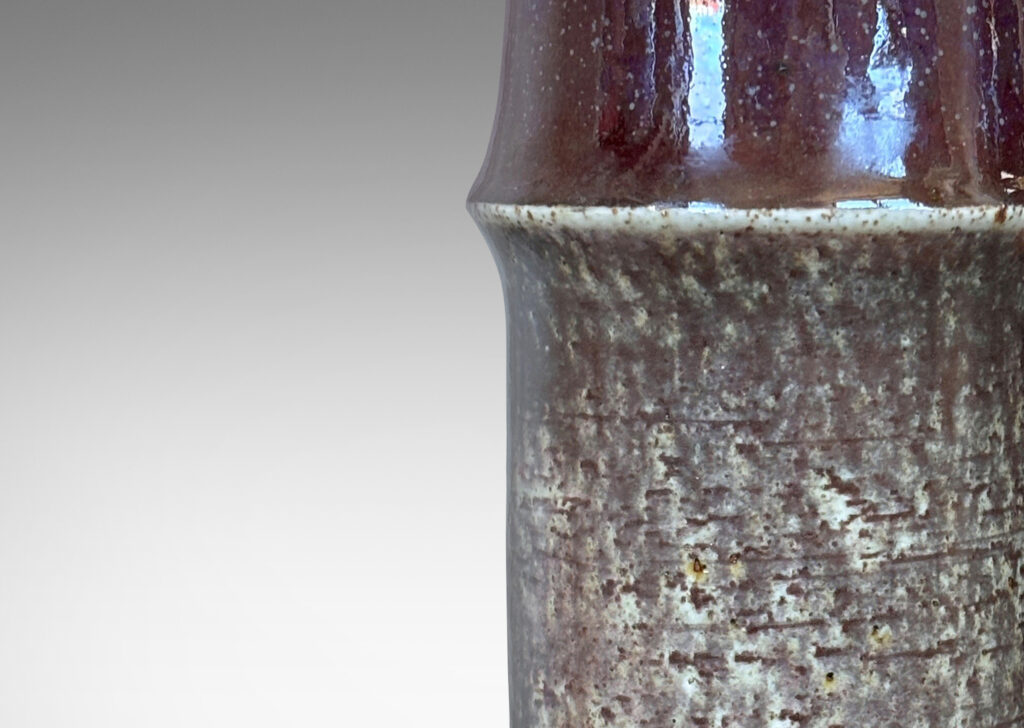 Gallery BAC notched cylindrical form with wonderful grog clay texture glazed in greenish gray, black and burgundy