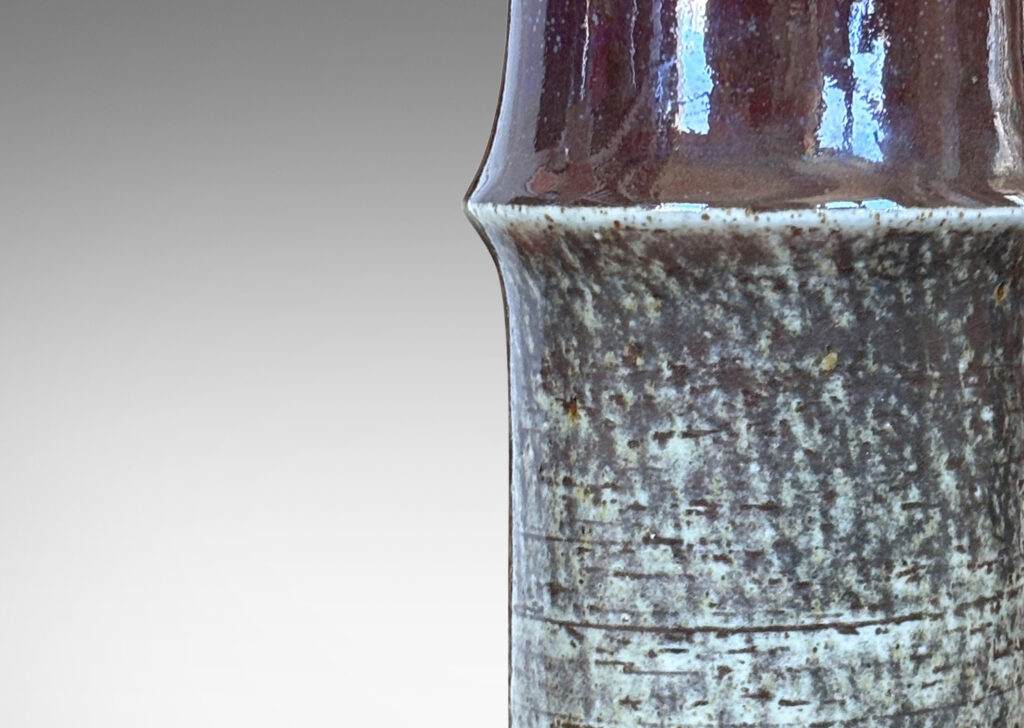 Gallery BAC notched cylindrical form with wonderful grog clay texture glazed in greenish gray, black and burgundy