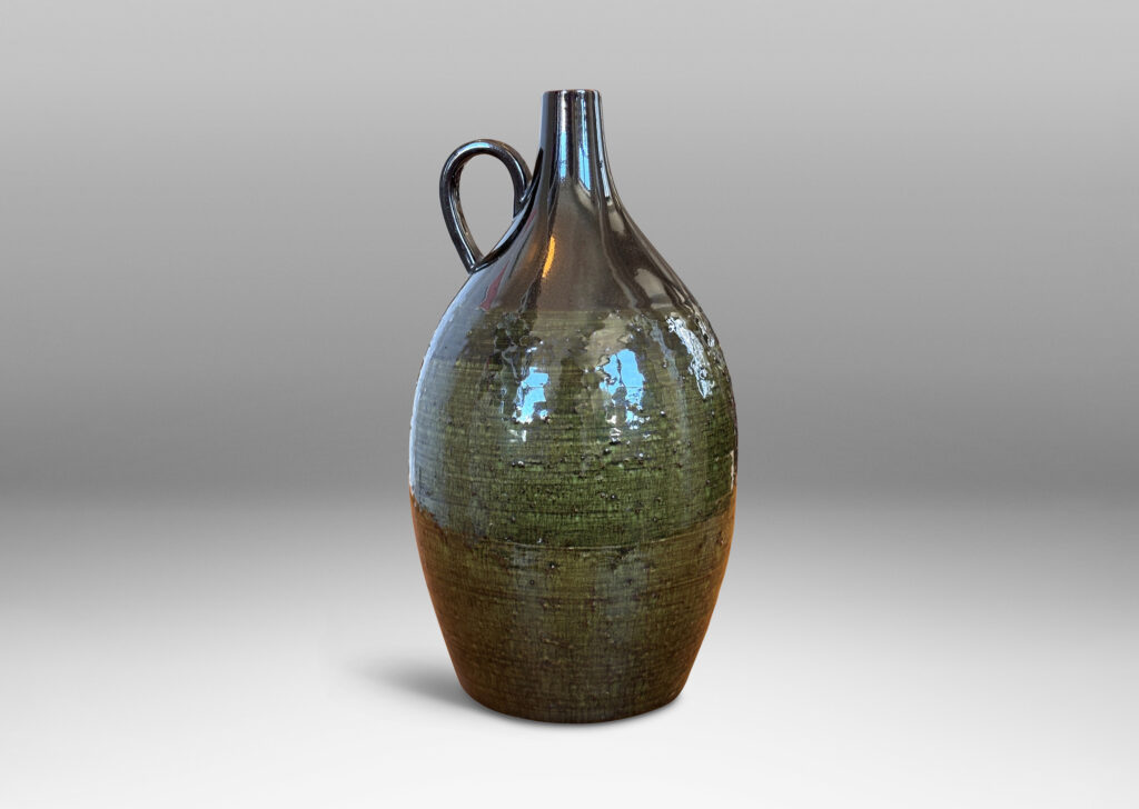 Gallery BAC ovoid form with sprouting neck and loop handles, glazed in brown-black and transparent olive green