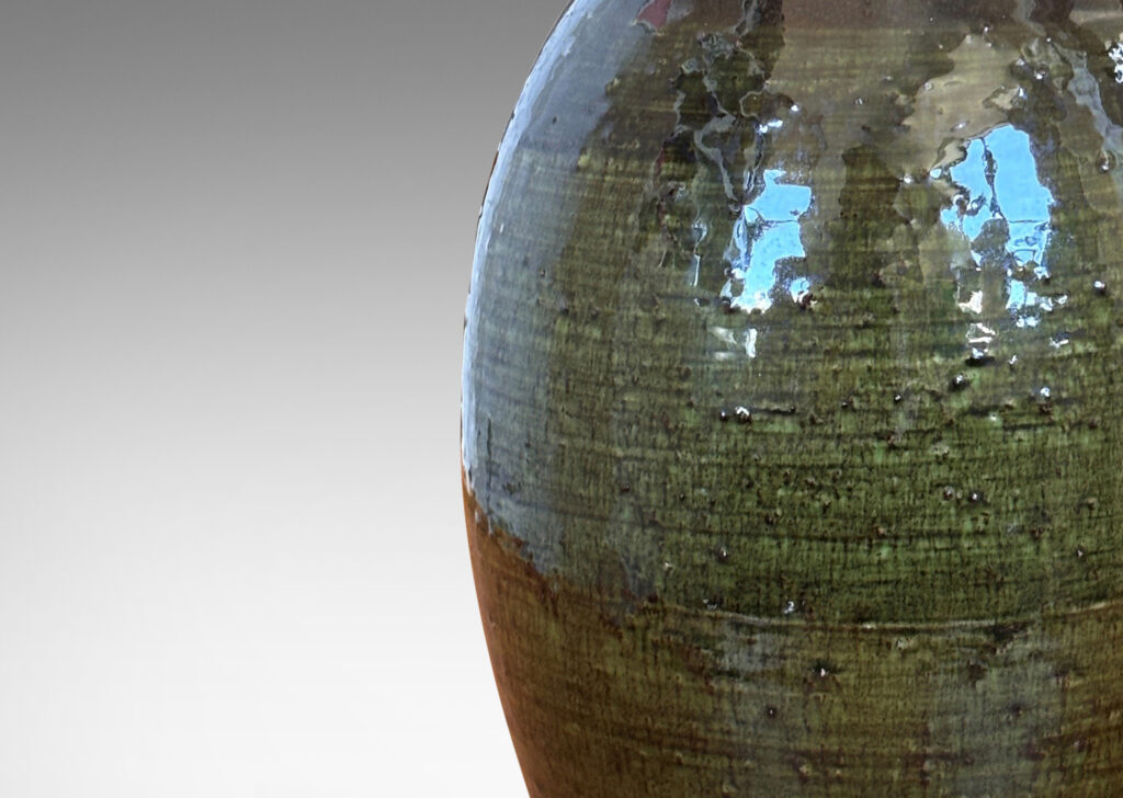 Gallery BAC ovoid form with sprouting neck and loop handles, glazed in brown-black and transparent olive green