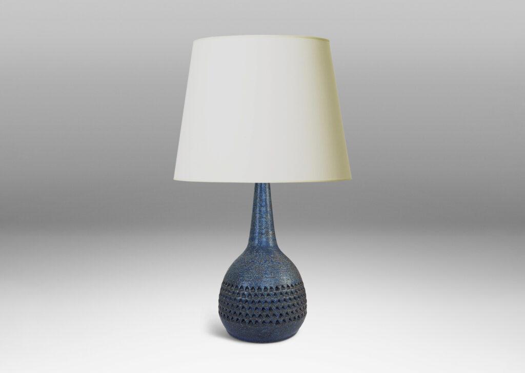 Gallery BAC bulbous form with rows of impressed triangular motifs and conical neck; glazed in a dark blue