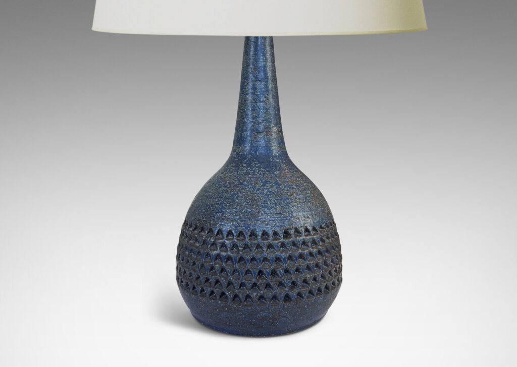Gallery BAC bulbous form with rows of impressed triangular motifs and conical neck; glazed in a dark blue