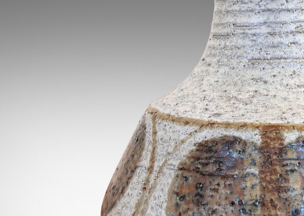 Gallery BAC ridged decanter-like form, glazed in a pale gray with painted geometric ornaments in light and dark brown