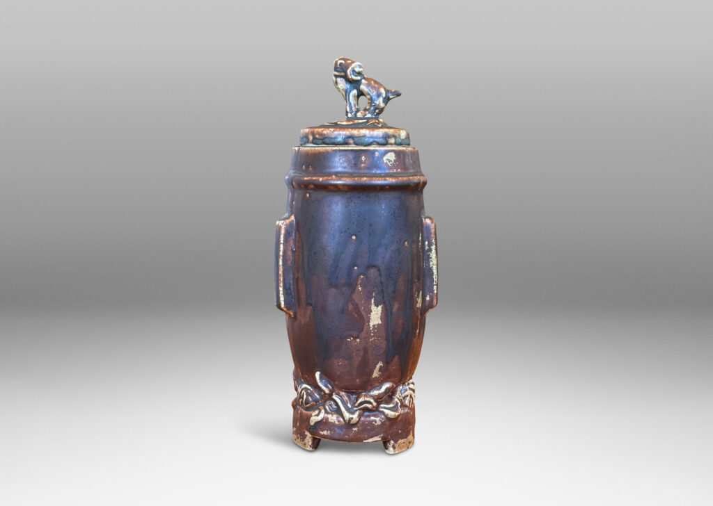 Gallery BAC swelling form with Chinese style articulated base, with relief foliate ornaments and doggie finial, glazed in a flowing matte brown