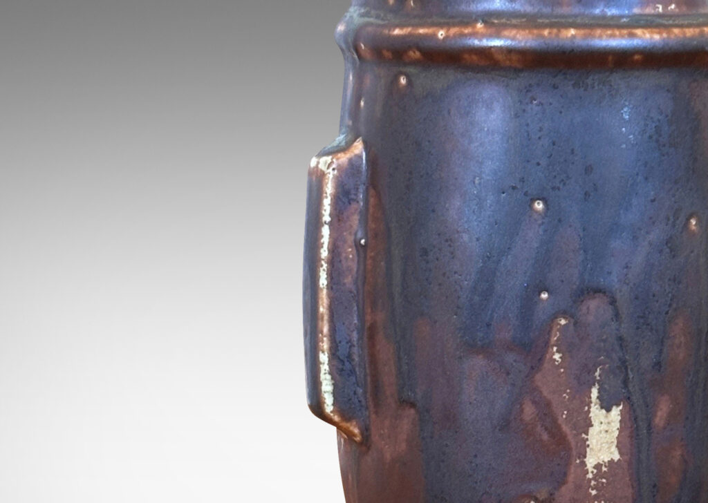 Gallery BAC swelling form with Chinese style articulated base, with relief foliate ornaments and doggie finial, glazed in a flowing matte brown