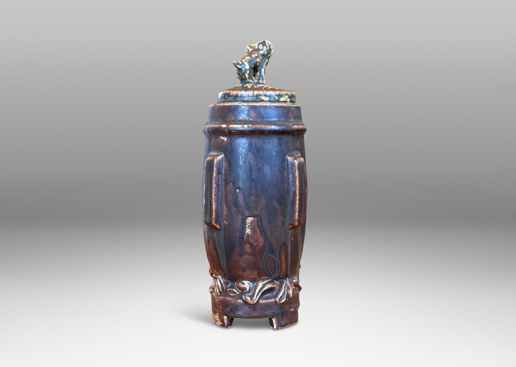 Gallery BAC swelling form with Chinese style articulated base, with relief foliate ornaments and doggie finial, glazed in a flowing matte brown