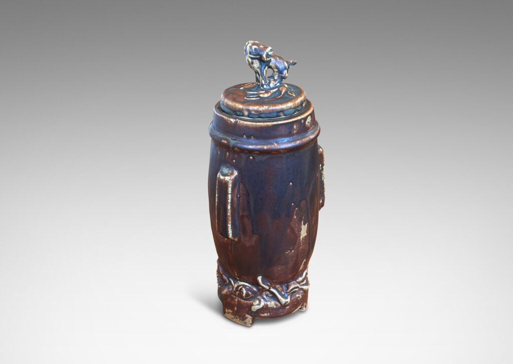 Gallery BAC swelling form with Chinese style articulated base, with relief foliate ornaments and doggie finial, glazed in a flowing matte brown