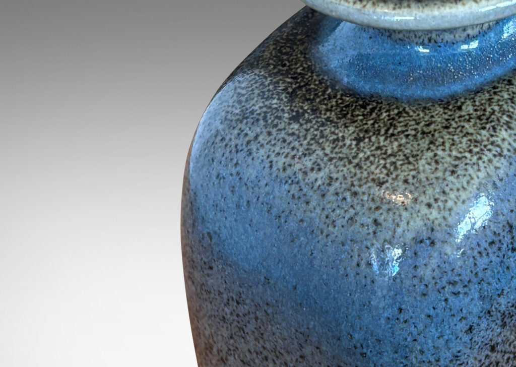 Gallery BAC bottle-like form with sloped shoulders and flanged cap, glazed in a grayish-blue with darker tone speckles