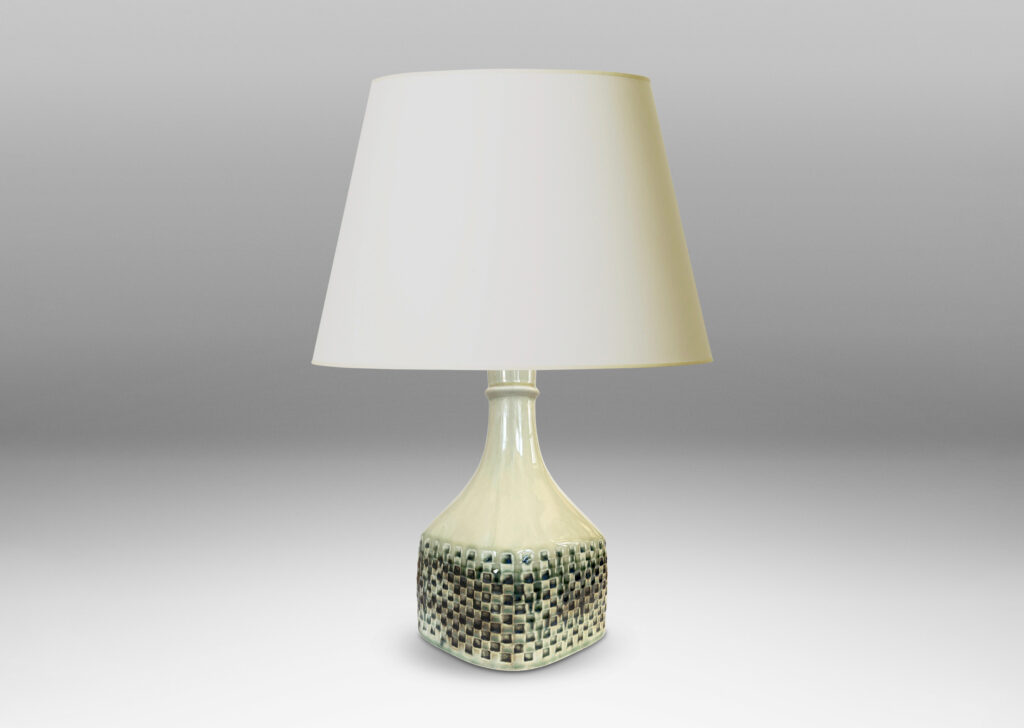 Gallery BAC square bottle-like form with checker reliefs and sprouting neck, glazed in ivory with flowing blue-gray