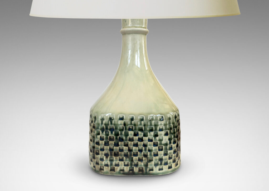 Gallery BAC square bottle-like form with checker reliefs and sprouting neck, glazed in ivory with flowing blue-gray