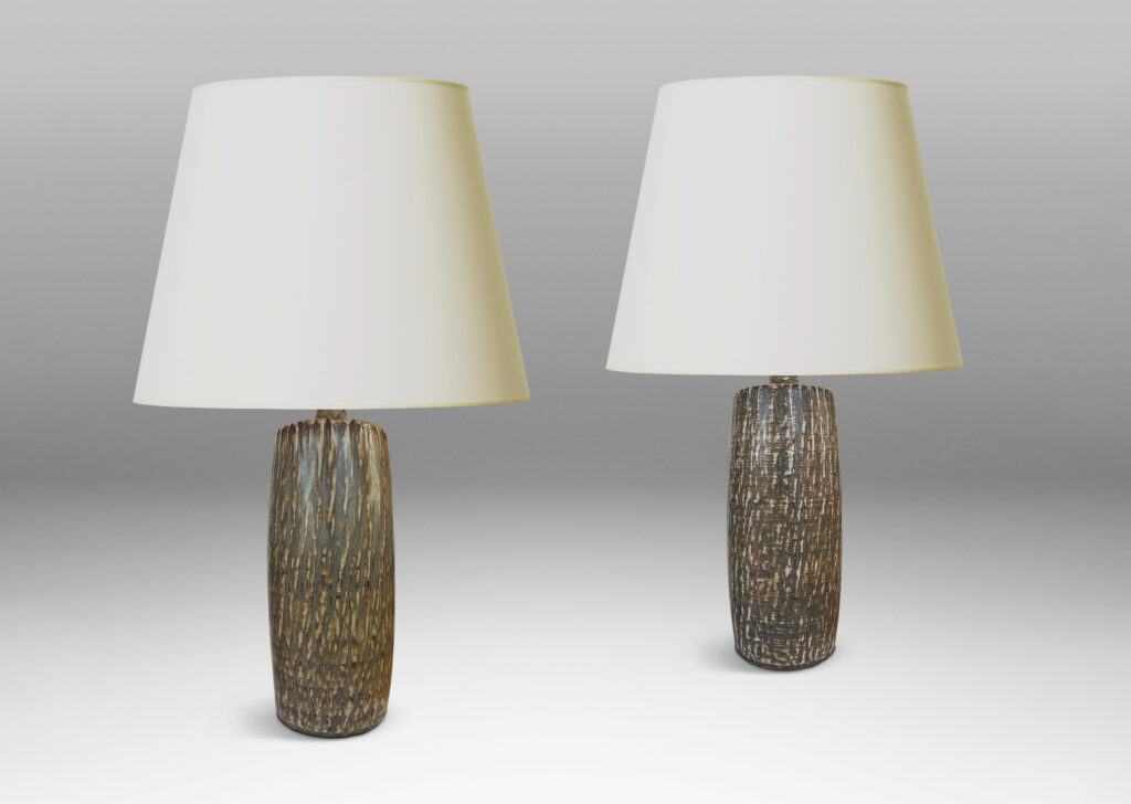 Gallery BAC swelling cylindrical forms with carved gouged surface and flowing brown glaze