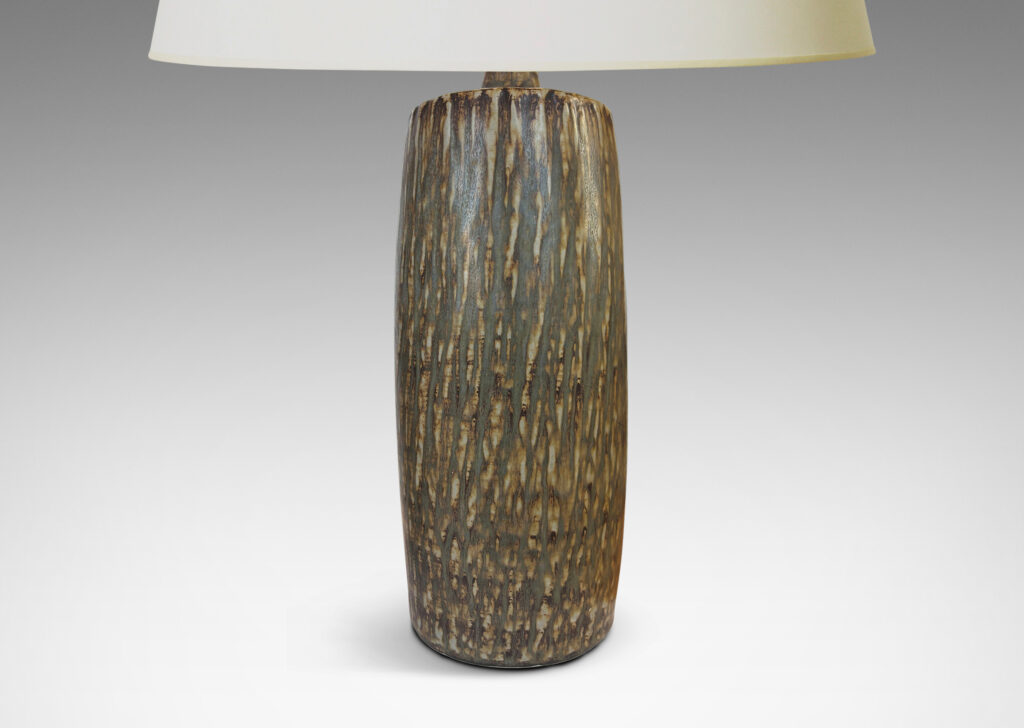 Gallery BAC swelling cylindrical forms with carved gouged surface and flowing brown glaze