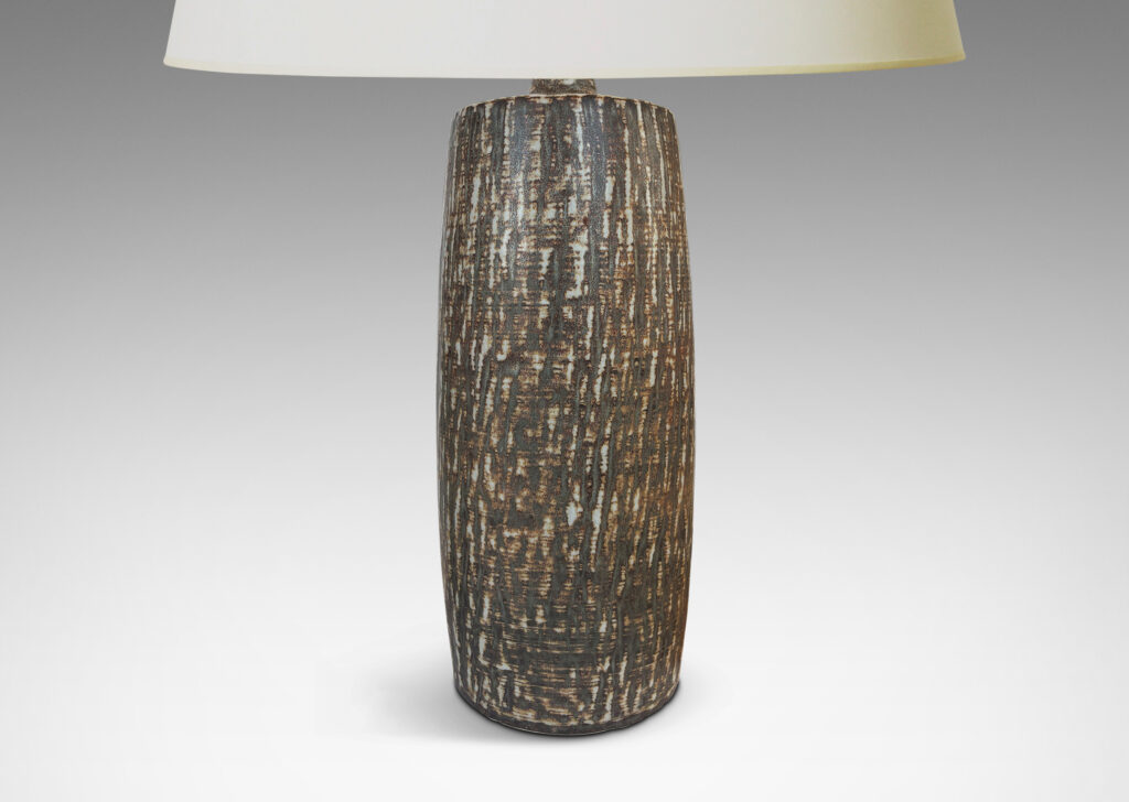 Gallery BAC swelling cylindrical forms with carved gouged surface and flowing brown glaze