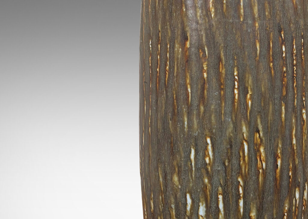 Gallery BAC tall swelling cylindrical form with cuff neck, carved with a diagonal hatch texture