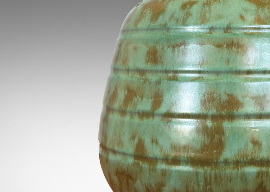 Gallery BAC gumdrop-like form with pinstripe bands on a flanged foot, glazed in a dappled celadon and olive green