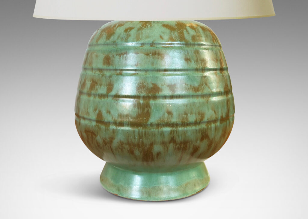 Gallery BAC gumdrop-like form with pinstripe bands on a flanged foot, glazed in a dappled celadon and olive green