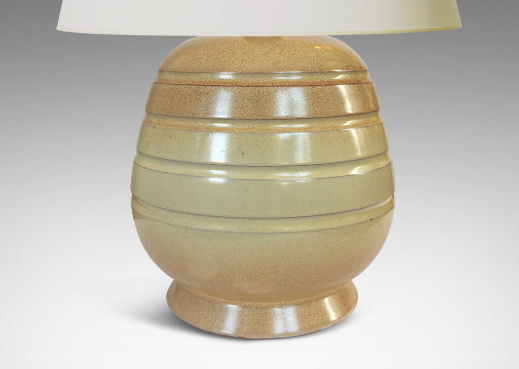 Gallery BAC gumdrop-like form with pinstripe bands on a flanged foot, glazed in ivory with graded tan accents