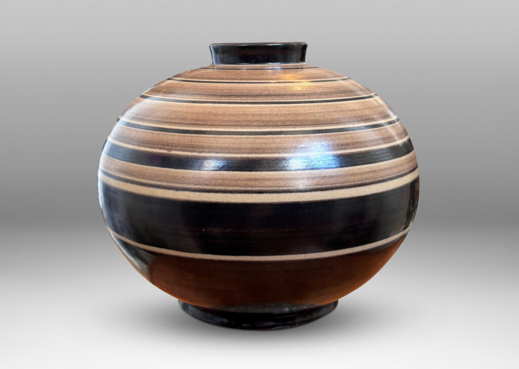 Gallery BAC compressed globe form with collar neck, glazed graded and solid brown bands against ivory