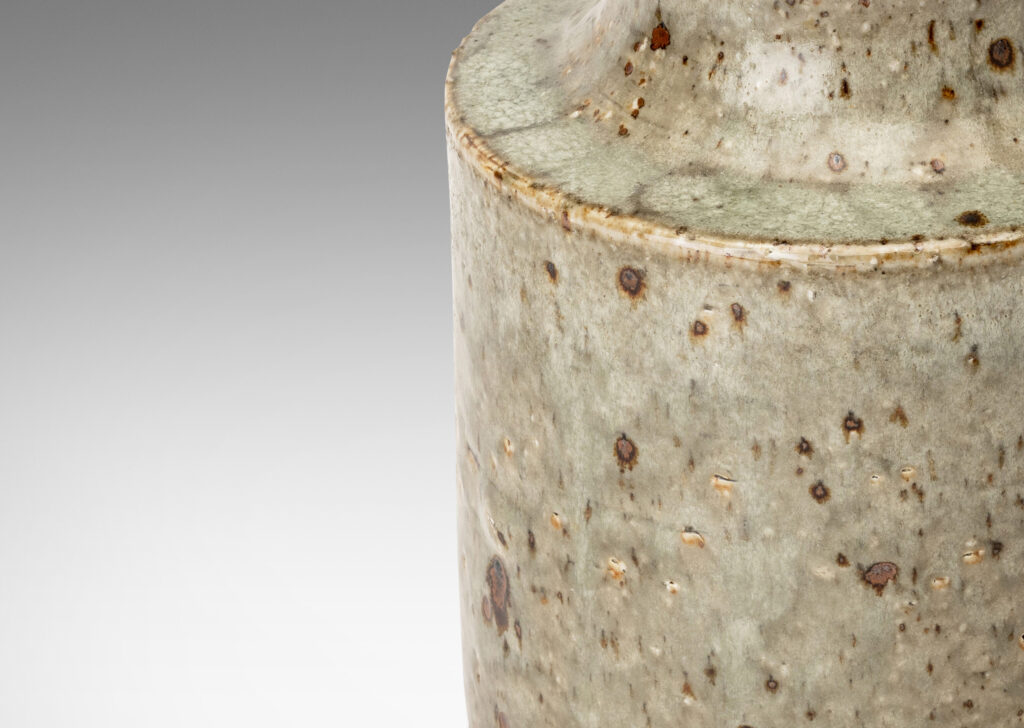 Gallery BAC cylindrical body and cove-sided neck, glazed in a greenish pale gray with dark dappling