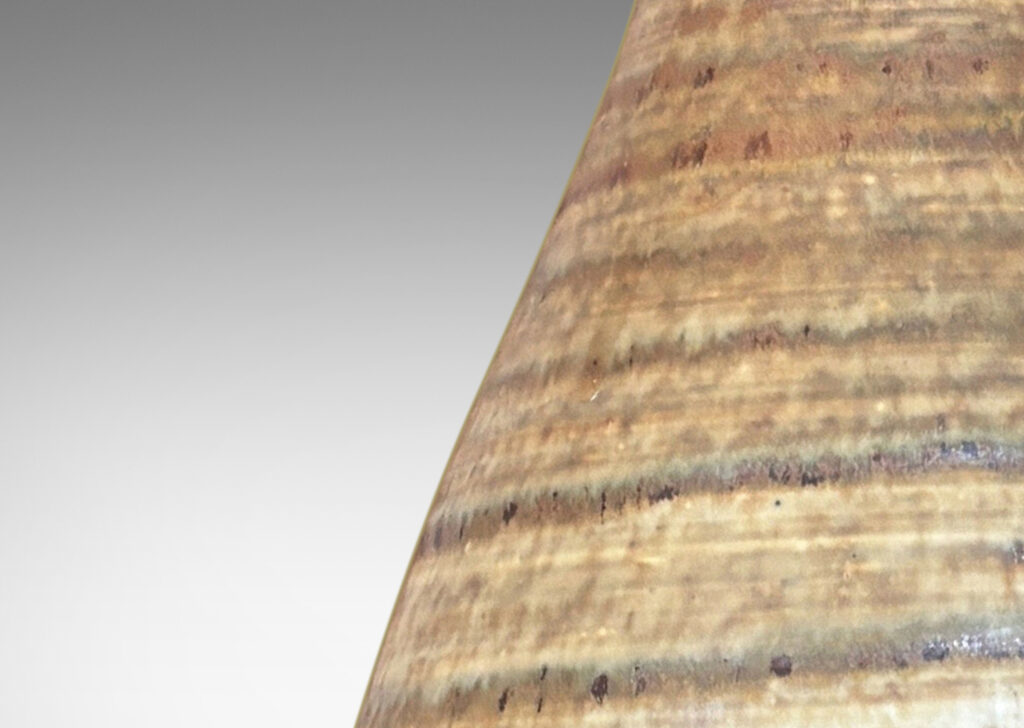 Gallery BAC swelling form with elongated neck, glazed in spiraling green-brown tones