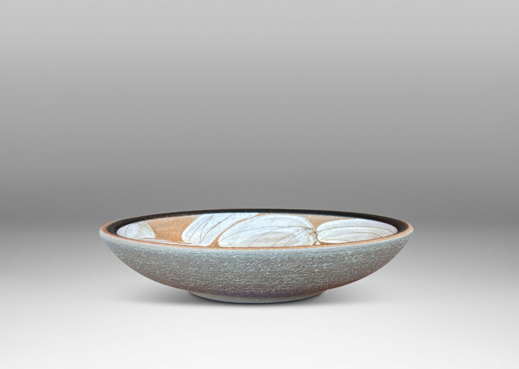 Gallery BAC concave form partially glazed with abstracted foliate design in black, ivory and brown