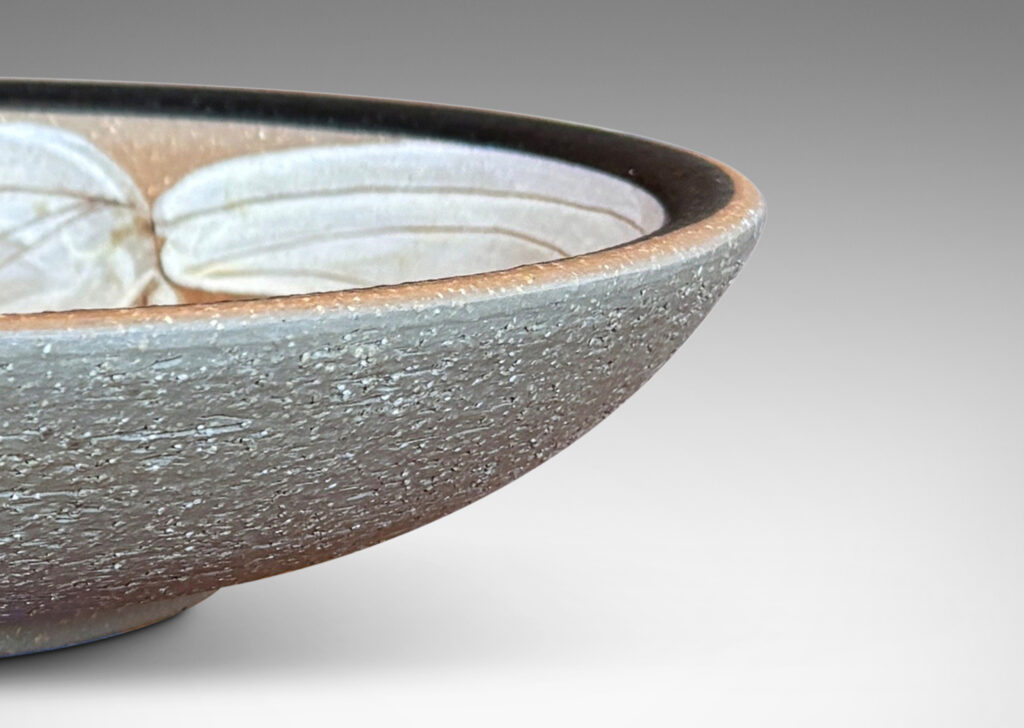 Gallery BAC concave form partially glazed with abstracted foliate design in black, ivory and brown