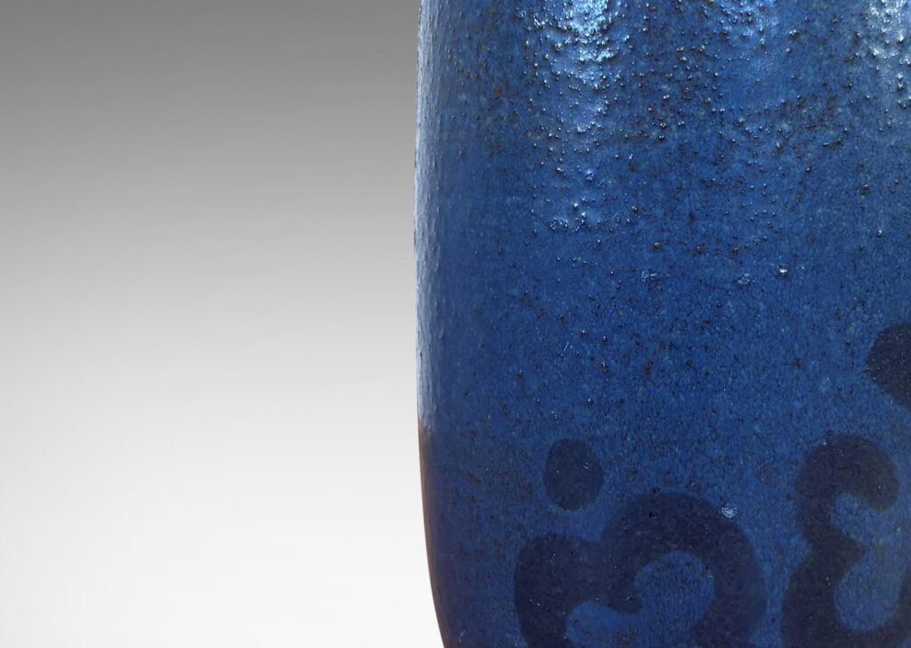 Gallery BAC ovoid form glazed in a thin medium blue with abstracted floral motif in black