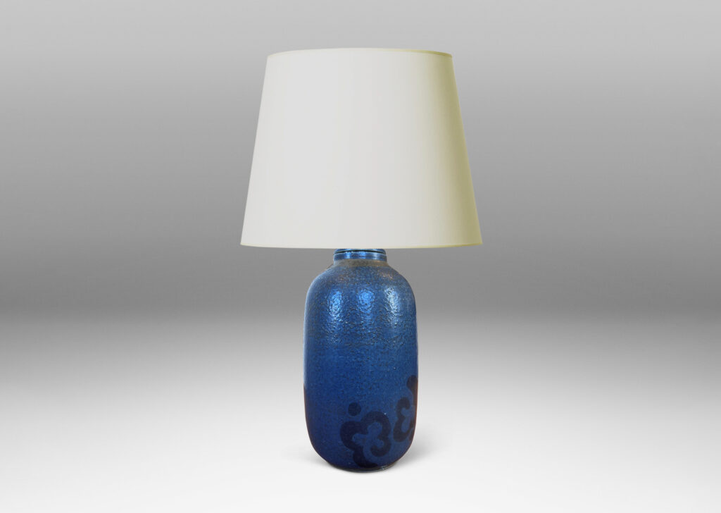 Gallery BAC ovoid form glazed in a thin medium blue with abstracted floral motif in black