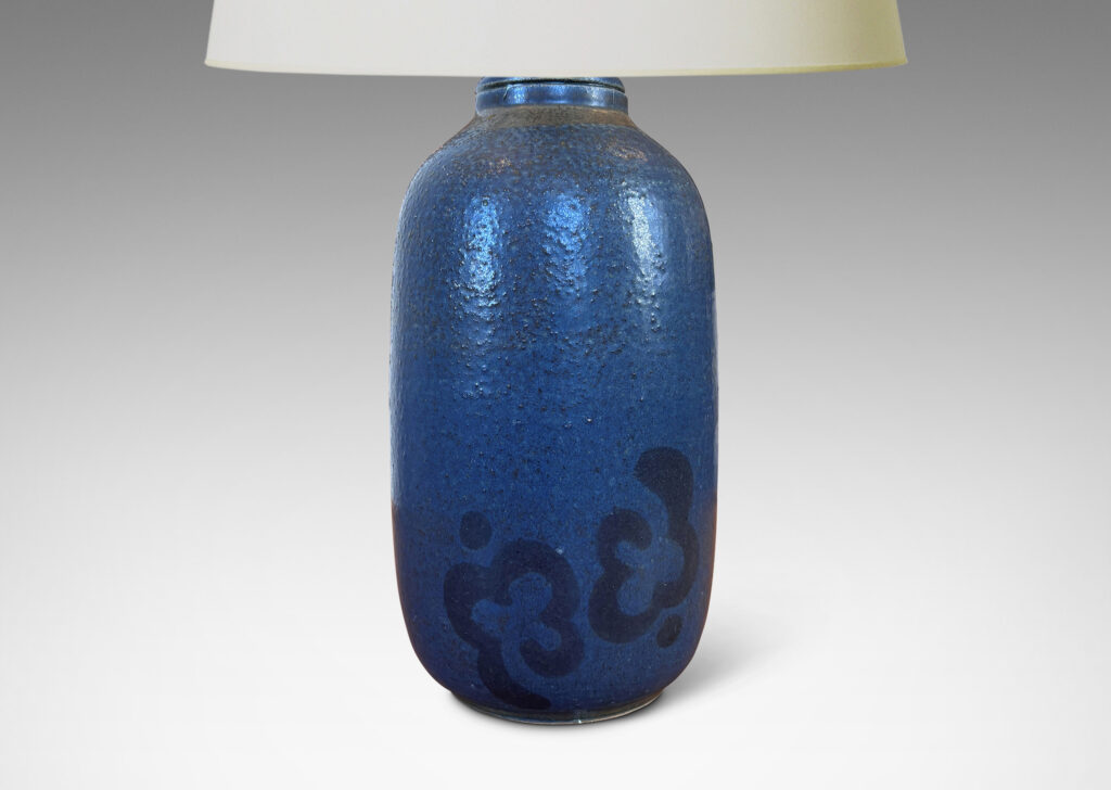 Gallery BAC ovoid form glazed in a thin medium blue with abstracted floral motif in black