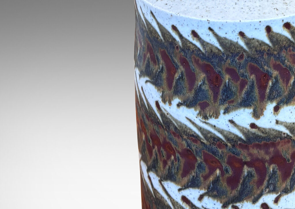 Gallery BAC cylindrical form in stippled pale gray over-glazed with rust and dark brown foliate bands