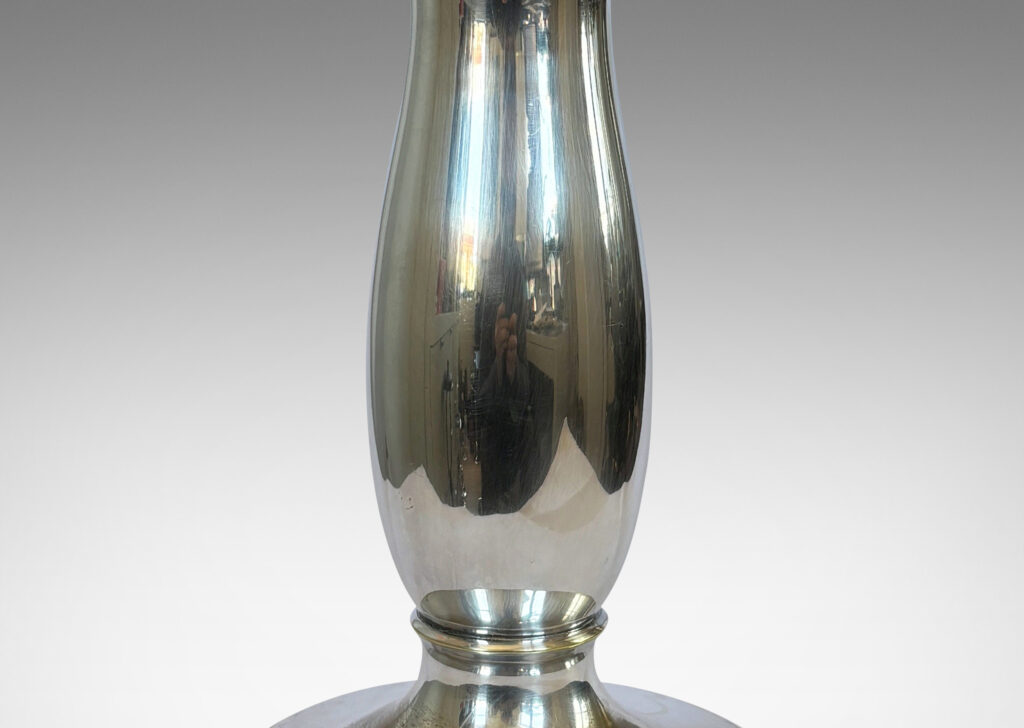 Gallery BAC sinuous vase form on a disk base encircled in foliate relief; silver plate