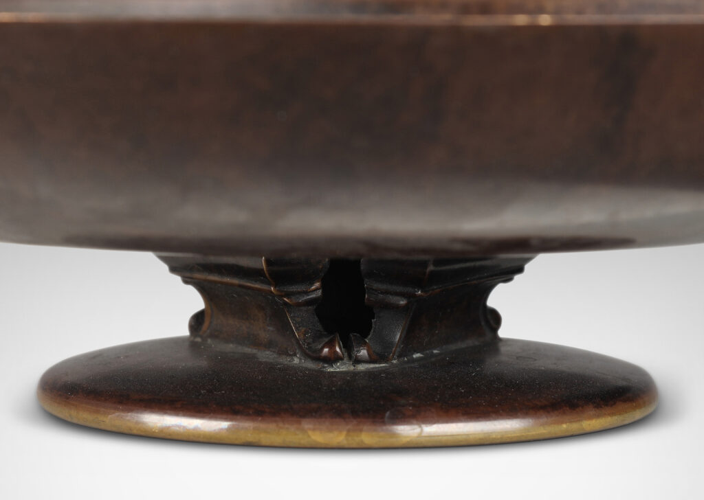 Gallery BAC shallow bowl form on a low stand mounted with baroque modeled brackets, with rich dark patination; bronze