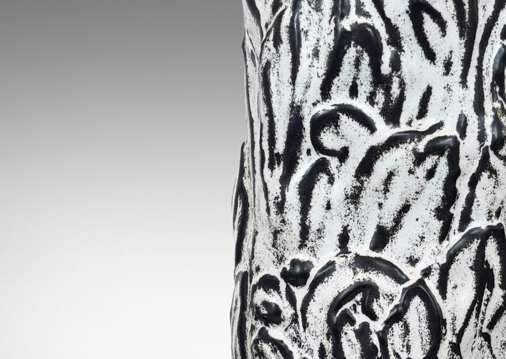 Gallery BAC columnar base surrounded in an energetic acanthus leaf pattern in deep relief, accentuated with a white-black tin glaze