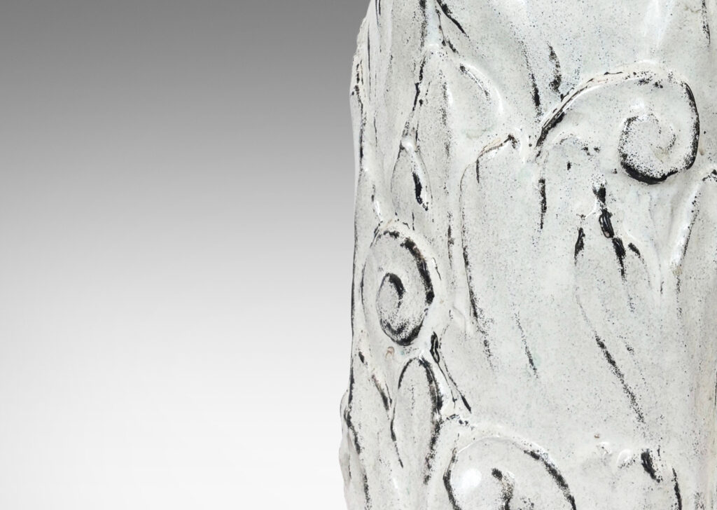 Gallery BAC columnar base surrounded in an energetic acanthus leaf pattern in deep relief, accentuated with a white-black tin glaze