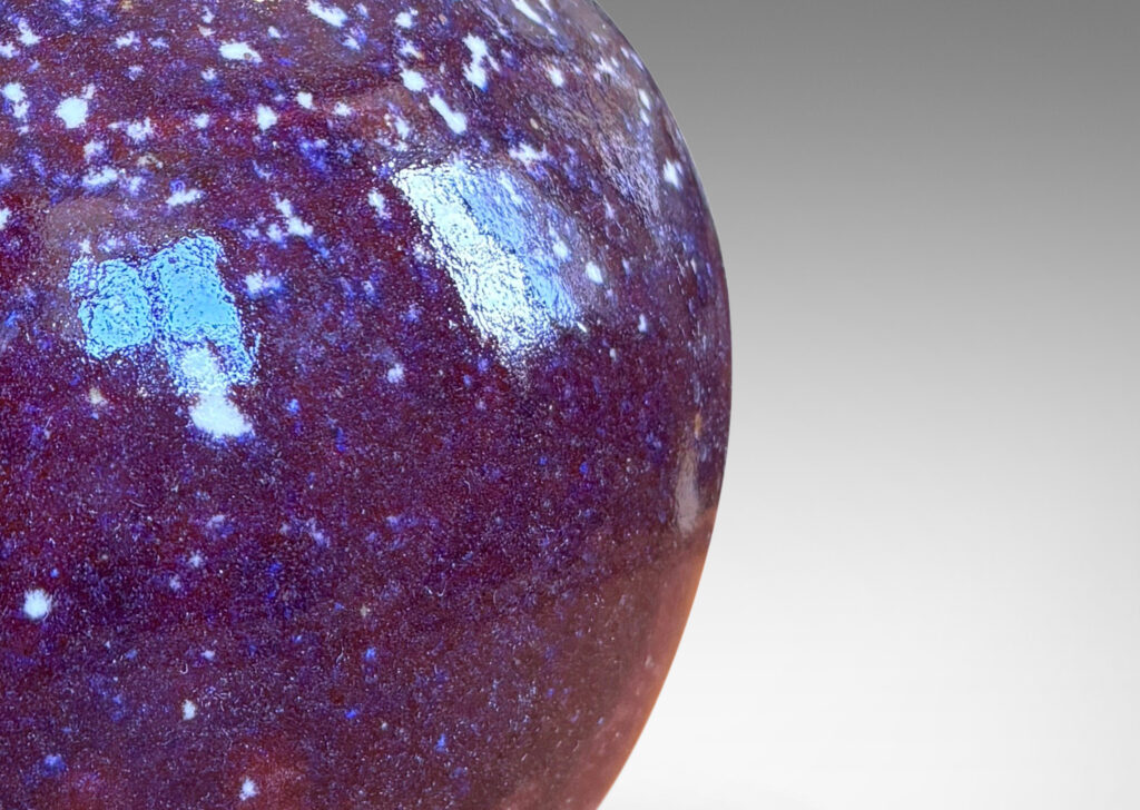 Gallery BAC plump bun form glazed in a violet-burgundy oxblood with pale gray accents