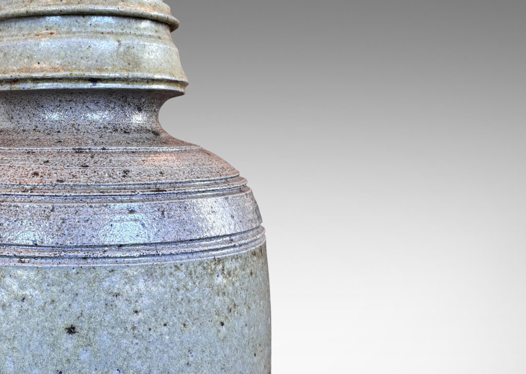 Gallery BAC columnar form with sculpted top, glazed in a light gray with brown dappling