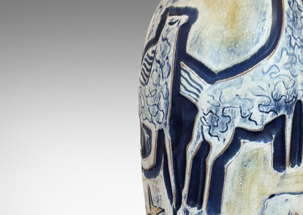 Gallery BAC elongated ovoid form with wonderful carved stylized horses and foliage, glazed in matte blues and yellows