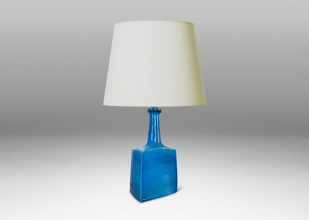Gallery BAC bottle-like forms, having squared bases and slender sprouting necks, glazed in a saturated azure tone